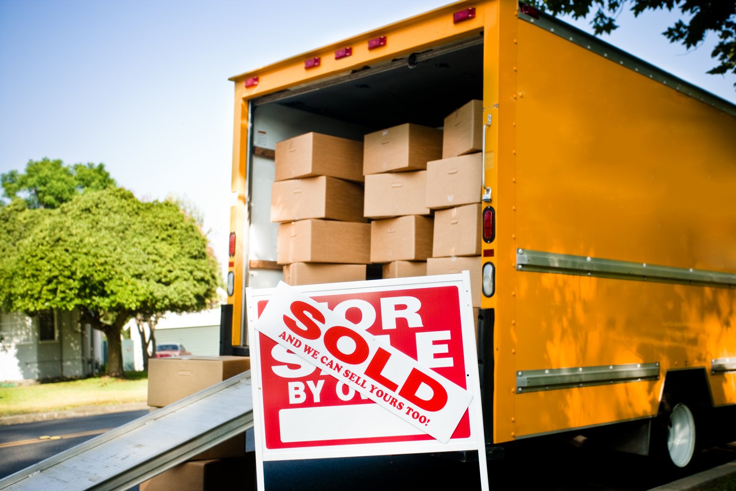 moving truck and sold sign